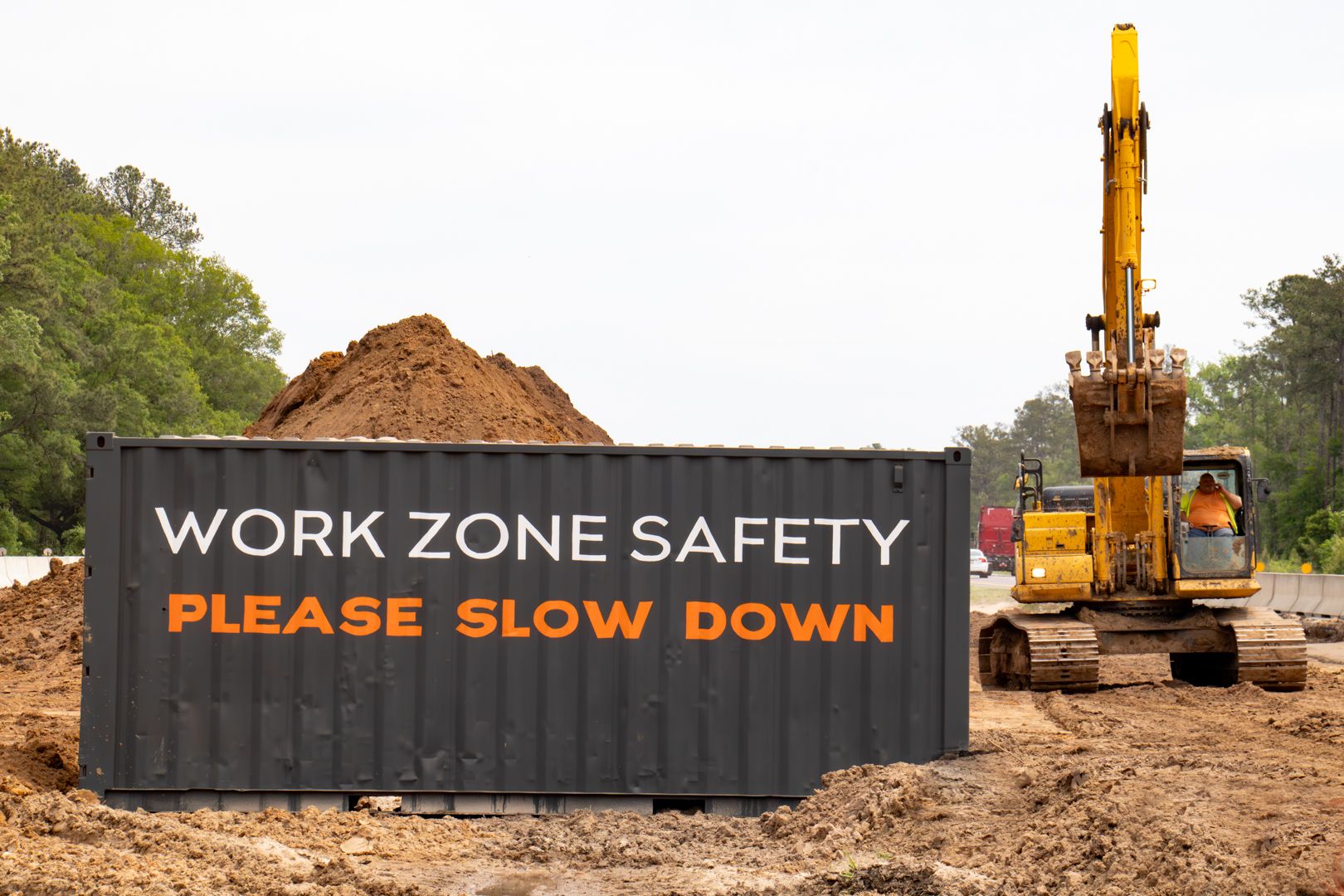 Branded shipping container on jobsite that says "Work Zone Safety Please Slow Down"