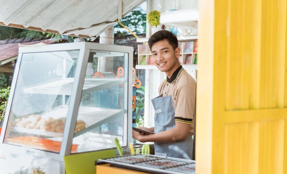 Man running cafe out of yellow shipping container
