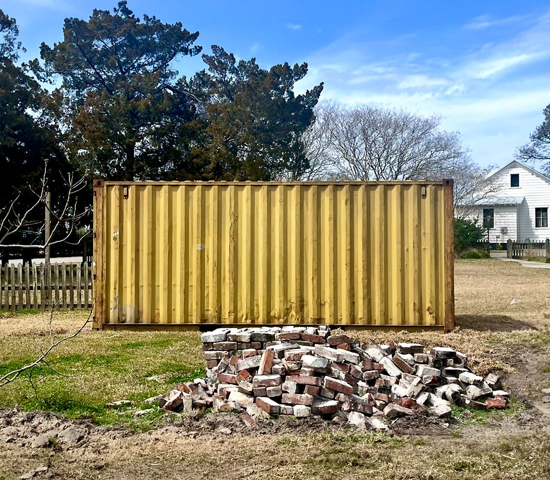 Yellow used shipping container on a construction jobsite