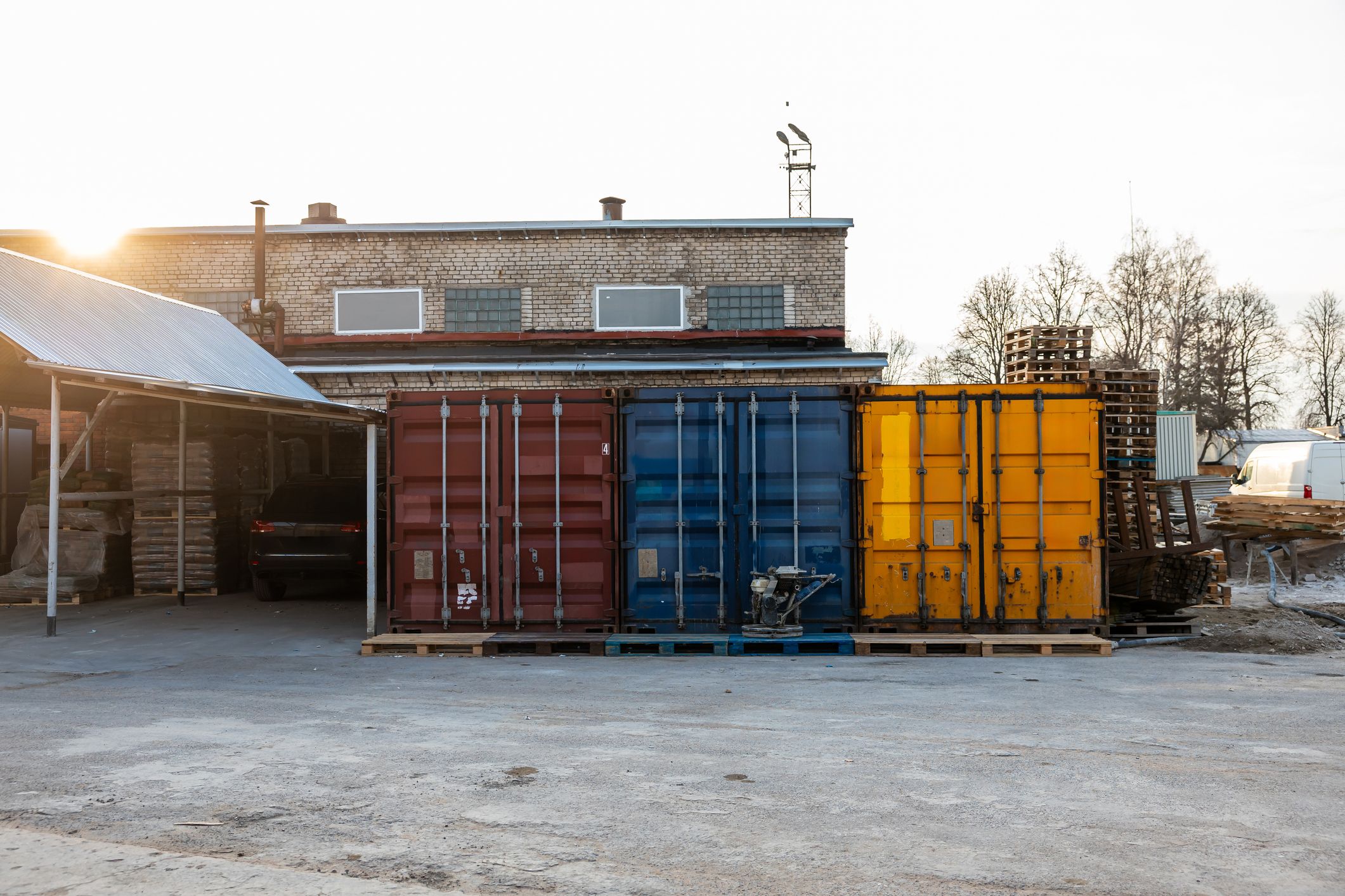 Red, blue and orange containers at an autobody shop