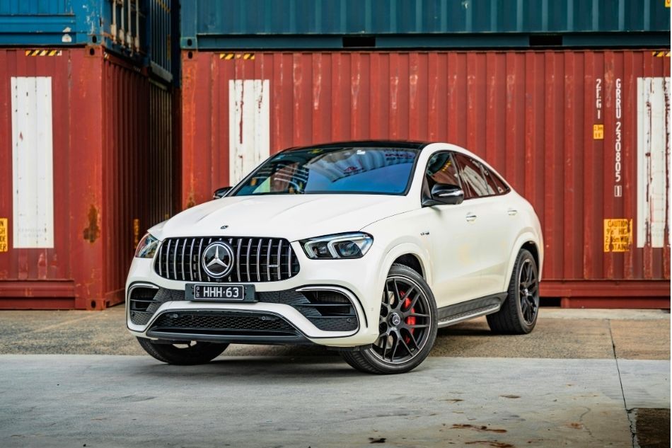 White car in front of red container