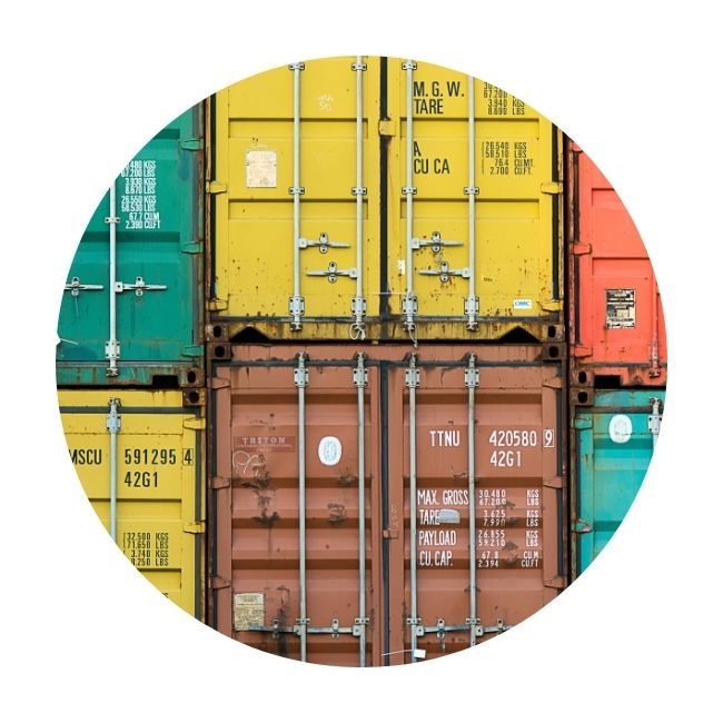 Variety of colors of shipping containers at depot
