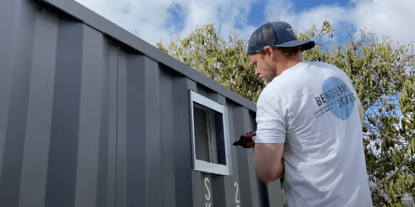 Man adding vents to a shipping container