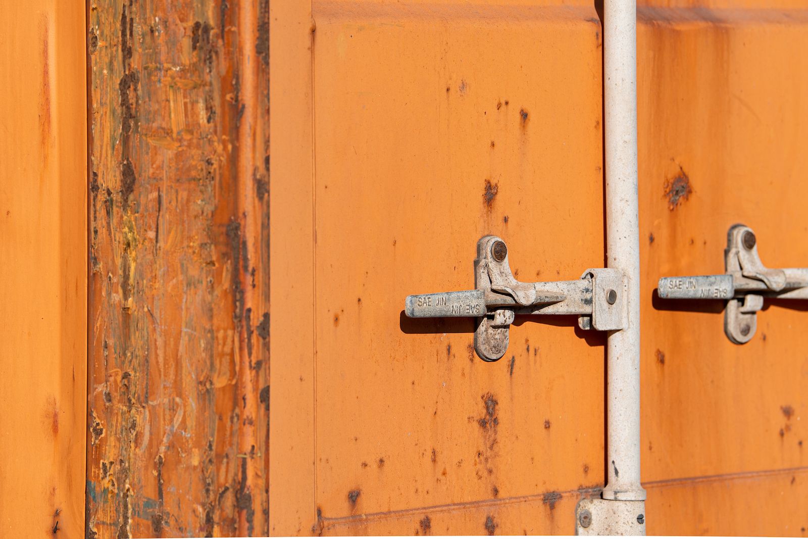 Orange container door with rust