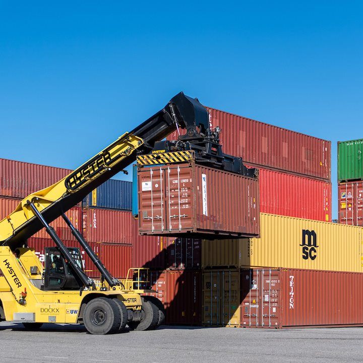 Two orange shipping containers stacked on top of each other