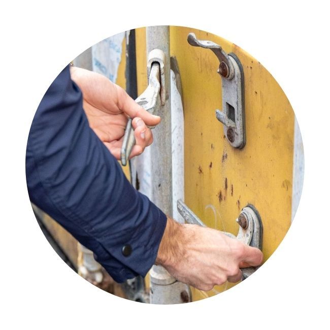 Man opening container doors by handles