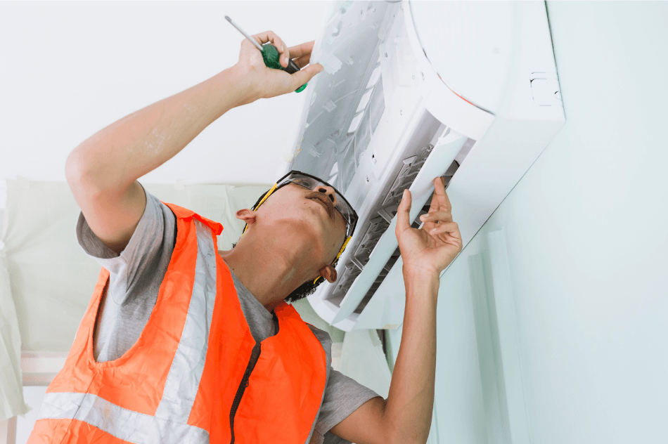 Man installing mini split HVAC system