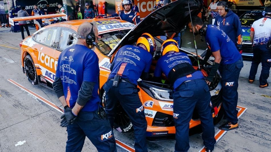 Group of men working on a car during the pit stop of a racecar race