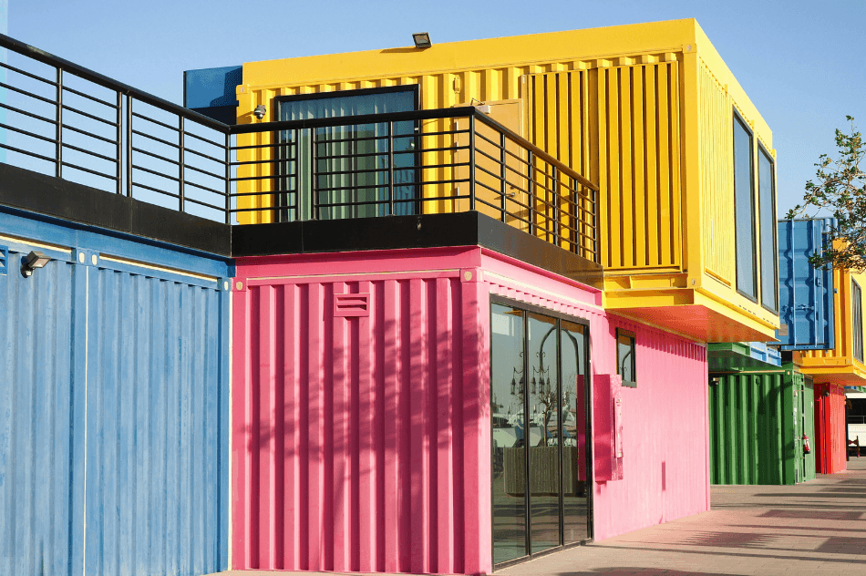 Colorful shipping containers that make a large building with multiple doors