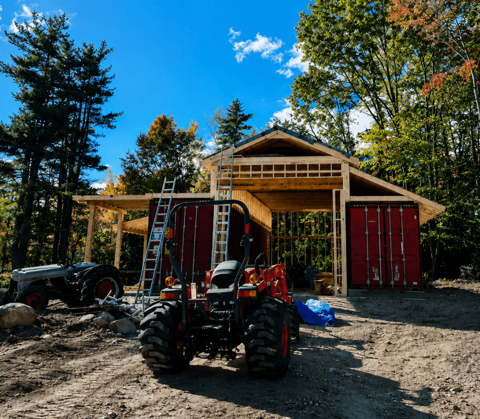 Roof being built over two containers with a tractor in front