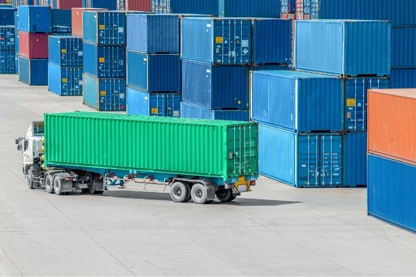 Truck carrying container in depot