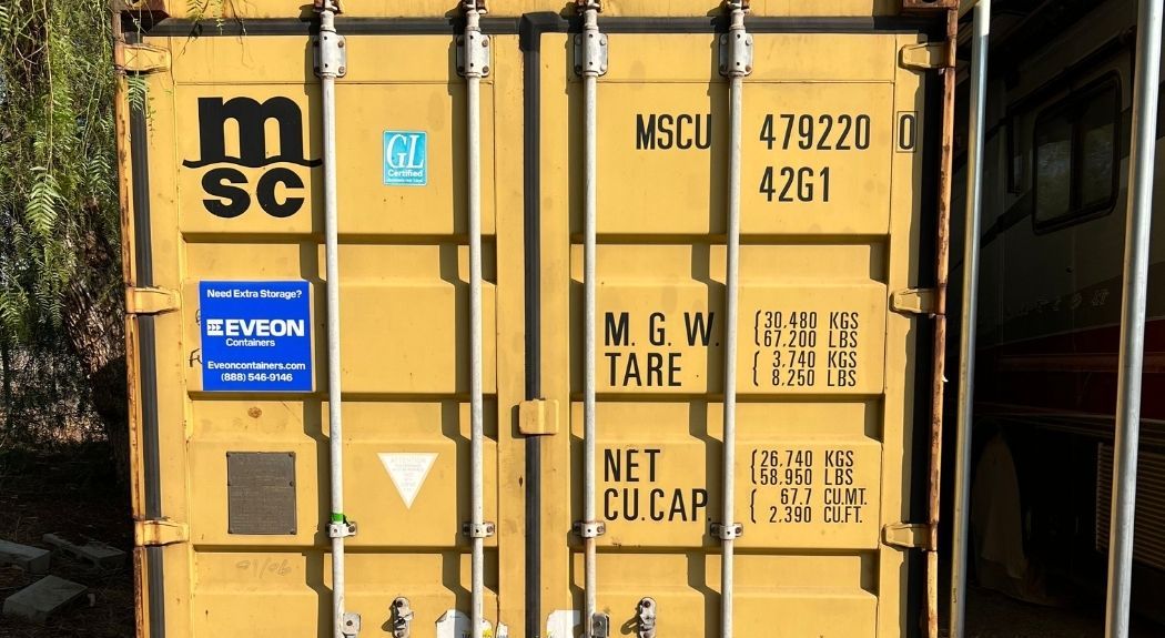 Yellow shipping container with weight information and an Eveon Containers sticker on the doors
