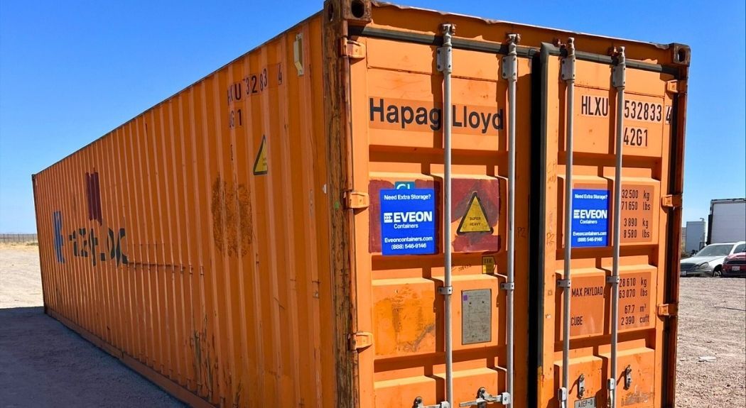 Orange shipping container with weight information and Eveon Containers sticker