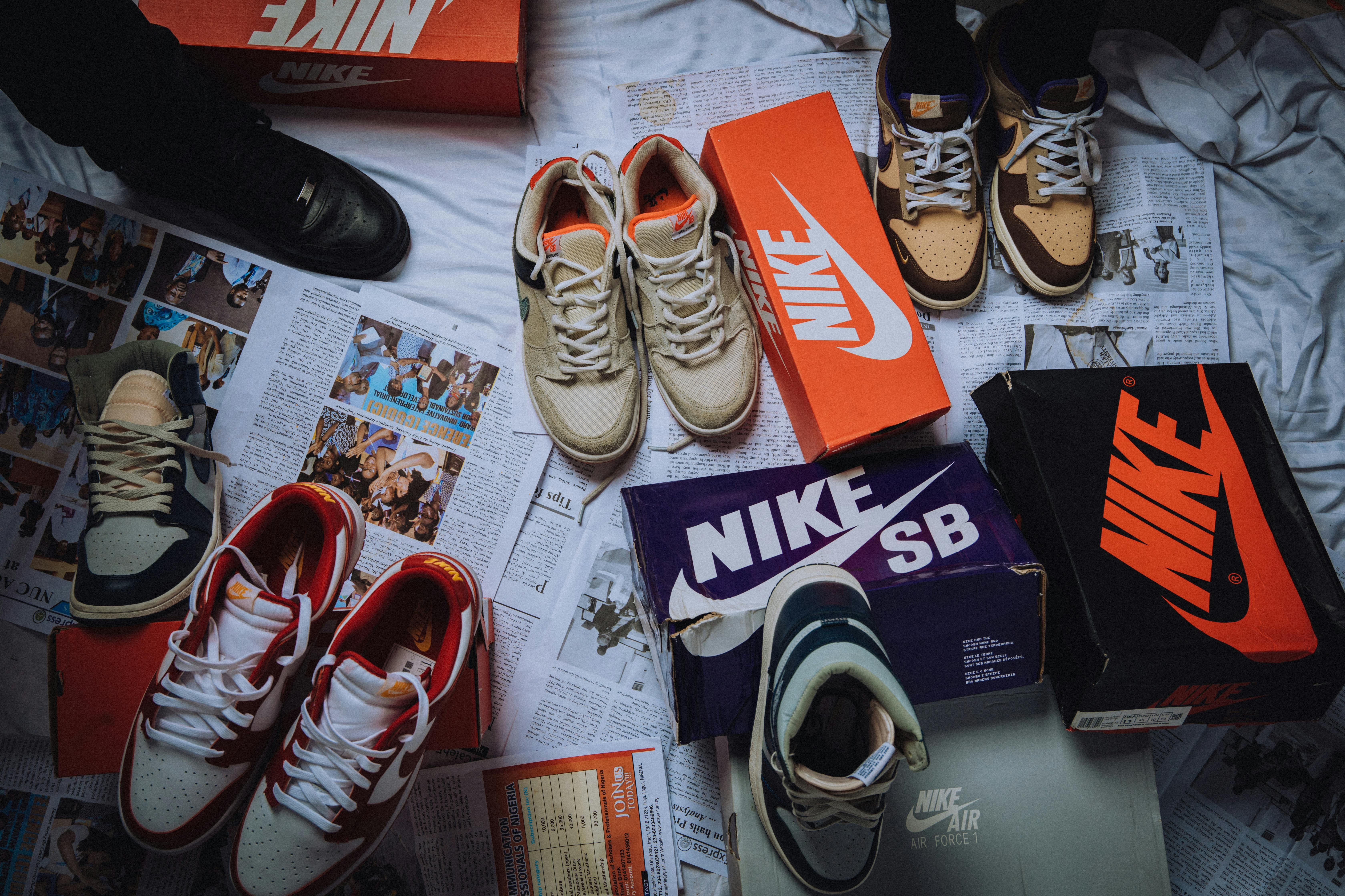 Nike shoes and boxes on top of a newspaper